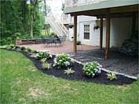 Patio With Sitting Wall and Flowerbed